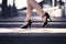 Woman walking in high heels in urban city street in summer. Chic stylish footwear. Elegant fashion style.