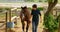 Woman walking with horse in stable 4k