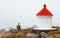 Woman walking at lighthouse foggy sea solo traveling