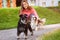 Woman walking Miniature Schnauzer and Cavalier King Charles Spaniel dogs in