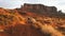 Woman walking in Monument Valley taking photos with smartphone.