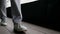 woman is walking over old wooden floor, closeup of feet, casual style for walk in city