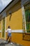 Woman walking past colonial house in Barranquilla, Colombia