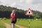 Woman walking past tick Infected area with danger sign