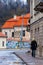 Woman walking by Radvilaites street with classical European architecture buildings, some painted with graffiti