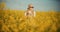 Woman Walking Through Rapeseed Field Portrait