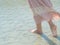 Woman walking on sand beach. Closeup detail of female feet .