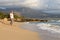 Woman walking on sand beach at golden hour