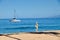 Woman walking the sand at Ka`anapali Beach on Maui.