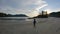 Woman Walking on Sandy beach on Pacific Ocean Coast View. Sunset Sky. San Josef Bay