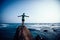 Woman walking on seaside rock cliff edge