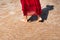 Woman walking by the seaside wearing red dress