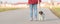 Woman is walking with a small cute obedient Jack Russell Terrier dog on a tar road