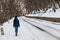 Woman walking in snow forest