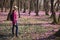 Woman walking spring forest and enjoy crocus flowers