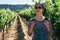 Woman walking in sunny grape field