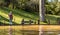 Woman walking in Terra Nostra park, thermal water pool, Azores