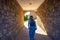 A woman walking to a tunnel leading to the yard of the Church of Lesnovo Monastir, Zletovo,