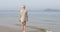 Woman Walking To Water On Beach, Young Girl Back Rear View