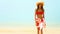 Woman walking at tropical beach in sunshine
