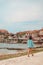 woman walking by umag city quay at stormy weather. copy space