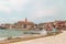 woman walking by umag city quay at stormy weather. copy space