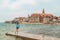 woman walking by umag city quay at stormy weather. copy space