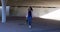Woman walking under flyover 4k