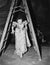 Woman walking under a step ladder with her fingers crossed