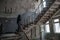 Woman walking up by stair at the abandoned building at the ghost town Chernobyl