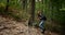 Woman Walking Uphill in Forest