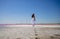 Woman walks alone on a deserted beach, solitude, serene, lonely concept. carefree vacation in nature
