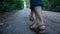Woman walks on a dirt road. Girl is walking through the park. Closeup legs, one woman walking. Cottagecore, nature lover