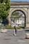 A woman walks in the historic center of Aosta, Italy, near the famous Arch of Augustus