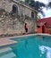 Woman walks next to a pool, she feels relaxed, fulfilled, calm, calm and well-being, she sunbathes in freedom and peace