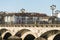 A woman walks by one of the ancient bridges of Pontevedra Spain