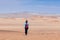 A woman walks through the Paracas desert, Peru.