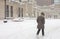 Woman walks to work in winter snowstorm downtown Chicago