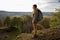 Woman wanderer enjoys view above valley