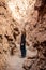 A woman wandering in canyon Mayor at Valle de la Luna Moon Valley, San Pedro de Atacama Chile. Wide view of stunning sun rise on s