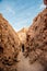 A woman wandering in canyon Mayor at Valle de la Luna Moon Valley, San Pedro de Atacama Chile. Wide view of stunning sun rise on s