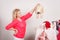 Woman in wardrobe holding furry hat