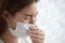 woman waring protection mask from coronavirus and air pollution coughing so sickness