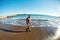 Woman in warm clothes walking along the seaside