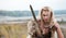 A woman warrior in the Scandinavian style of Vikings dressed in a wolf`s skin is standing with a sword in his hands