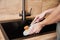 Woman wash dishes with wooden eco friendly brush. Zero waste concept