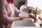 Woman washes beautiful dishes in a new sink on the kitchen in the morning