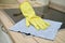 A woman washes an electric induction cooker with a rag when cleaning a home kitchen