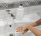 Woman washes her hands in the bathroom with special soap. Personal care and hygiene.