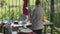 Woman washes her hands after clean dishes in the kitchen, summer cottage